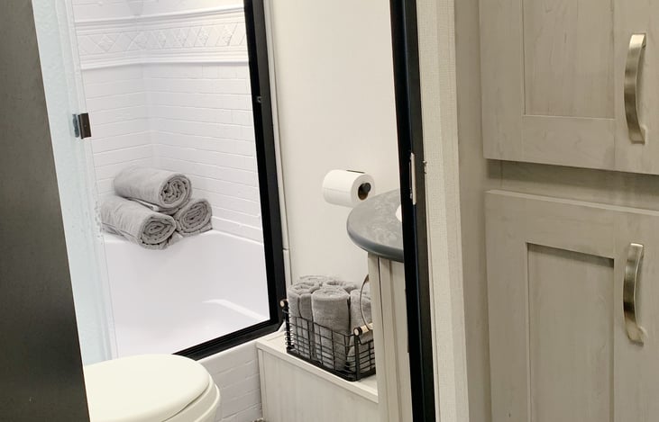 Fresh, soft bath towels, hand towels, wash cloths, hand soap, toilet paper is provided. A medicine cabinet is located above sink with containers to hold toiletries. Several towel hooks available.