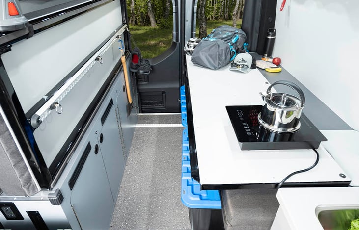 The bed platform doubles as a large cooking a preparation surface. We have bins that fit conveniently under the table that we can include for your additional gear.