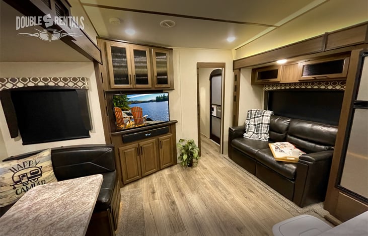 Roomy Living Area with Pull-Out Sofa, Entertainment Center and U-Shaped Dinette