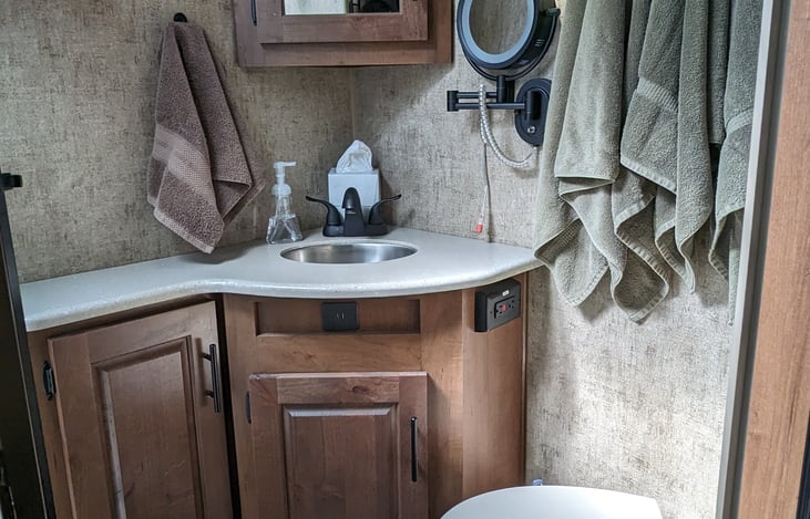Additional counter space in the bathroom along with a lit make-up mirror! Towels available as an additional add-on.