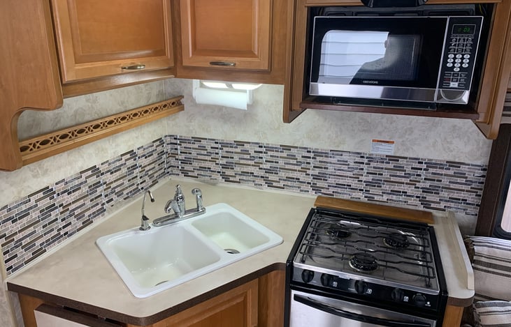 Microwave, 3 burner stove, small oven.