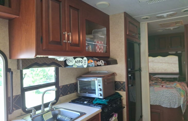 kitchen sink, toaster over, utensil & kitcen accessories storage.