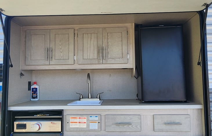 outdoor kitchen complete with griddle cooktop