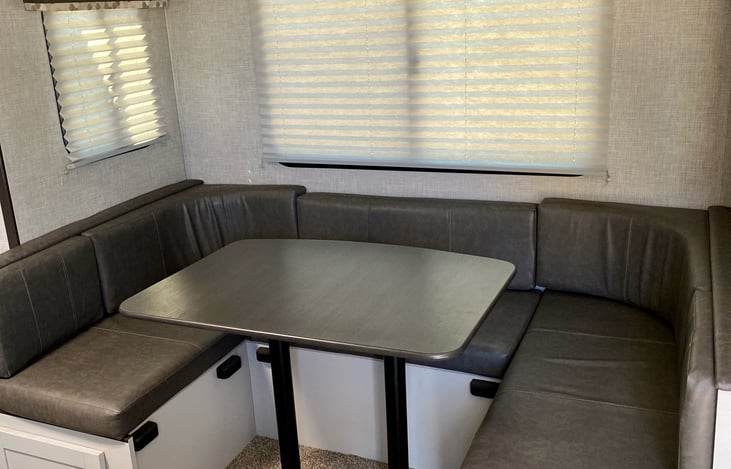 Comfortable U- shaped dinette that converts into a bed.