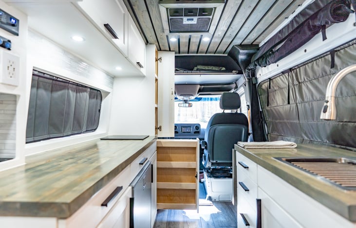 Tons of countertop space, a built in induction cooktop, a sink with warm water, and so much overhead storage for your belongings!