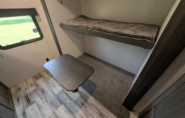 The couch was removed in order to accommodate more storage, turn area  into an office with the upper bunk folded up or add a twin size camping bed with Air Mattress. The options are limitless.