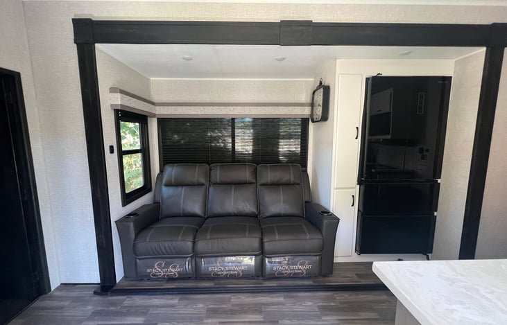 Massaging and heated, recliners and center console with charging ports and cup holders. Eating trays that attached are also located under the kitchen sink.