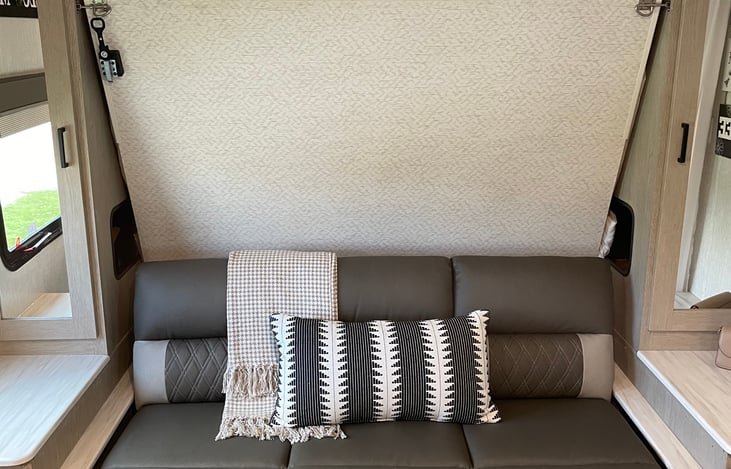 FRONT BED IS A MURPHY BED CAN BE FOLDED UPWARD AND HIDDEN OUT THE WAY AND TURNED INTO A FOLDABLE COUCH.