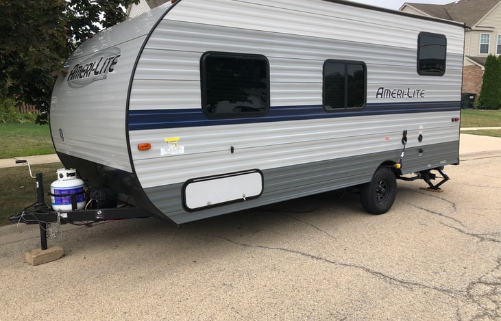 Side 2 of RV, with storage, power, water access, and tank emptying access (Black and gray tank)