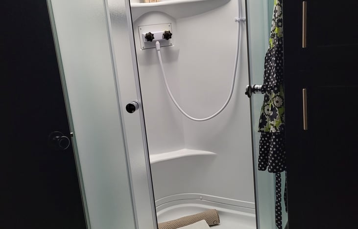 There is a domed sunroof in shower to accommodate 6 ft + tall guests.
