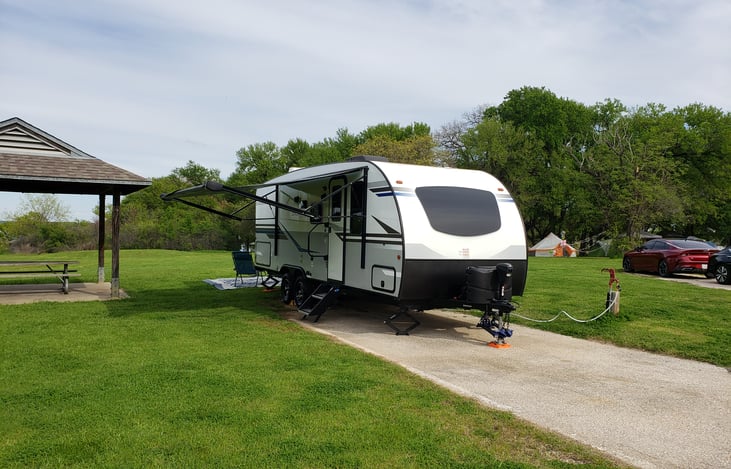 The front of the travel trailer has a large window to allow natural sunlight. All windows are tinted to allow visibility out but restricts visibility in.
