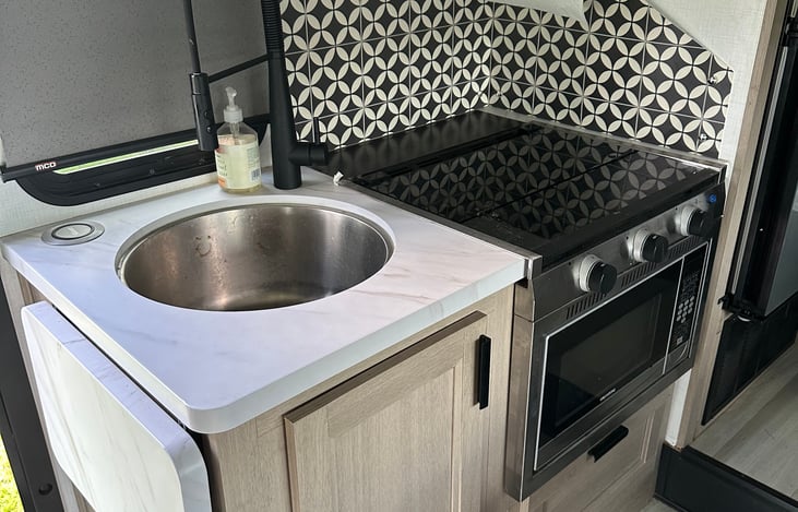 Microwave and convection oven, cooking utensils and silverware come stocked.