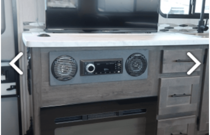 Pop-up TV on counter above the fireplace and stereo