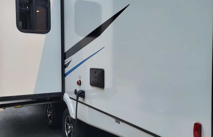 Outdoor shower with hot & cold water, teak platform to use while rinsing off after a day on the beach.