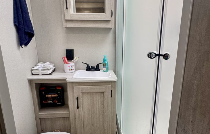 Full bathroom with the round shower and stocked with fresh towels!