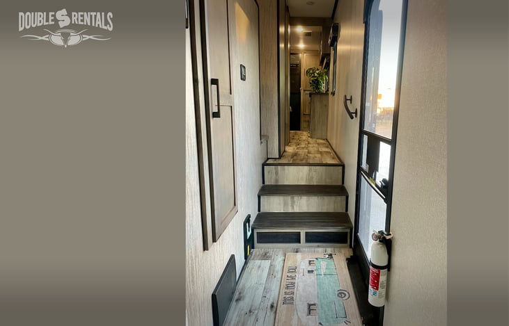 Hallway with Closet, Stairs, Central Vac System, and Touchpad Control Center.