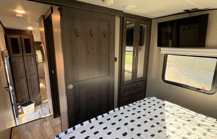 Bedroom facing door and closet