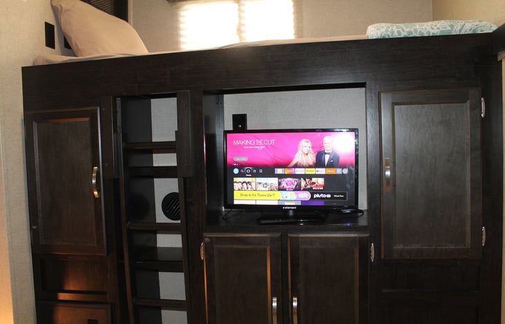 Bunk room offers two twins and a fold out love seat as well as a TV.