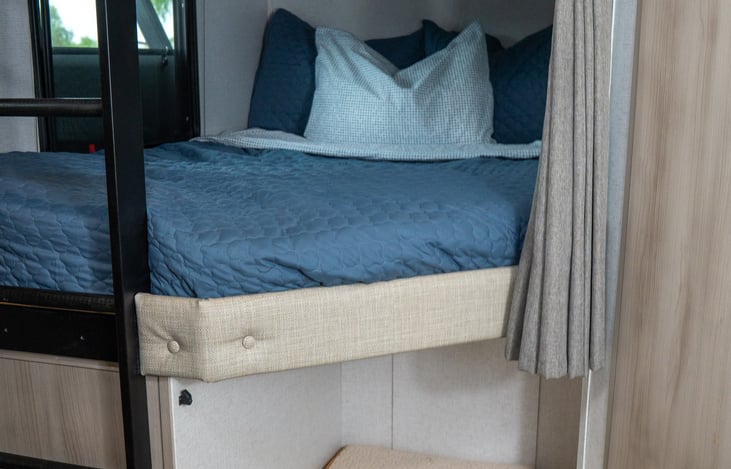 full sized bunks with storage nook for dog bed or luggage