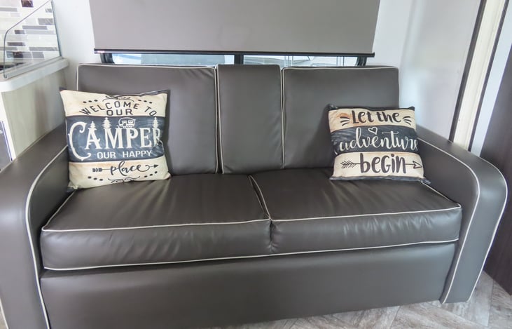 Sofa converts to a bed or the center console pulls down to create a handy place to store drinks while traveling.