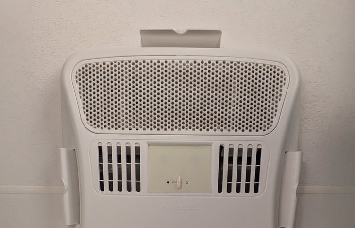 Air conditioner unit at the center of the RV on the ceiling. Adjustable vents.