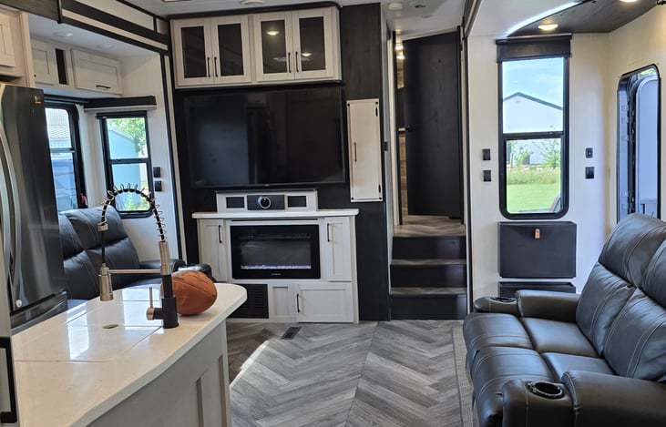 Living area , smart TV. Range has never been used. Super clean fridge.