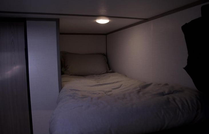 The top bunk bed is comfy for sleeping or ideal for storing extra luggage/items.