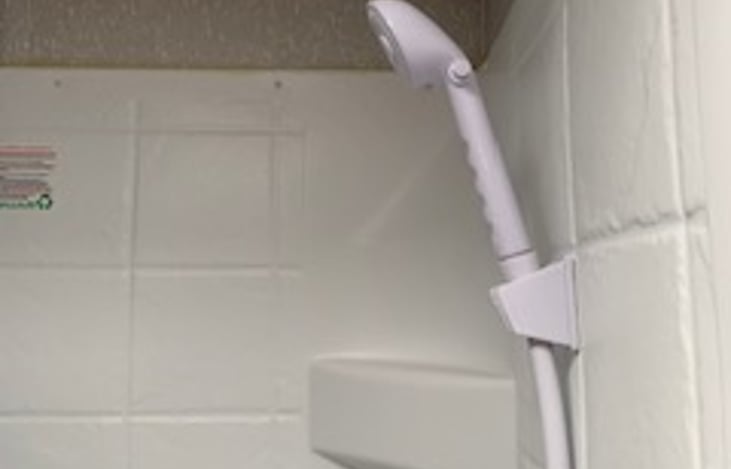 Cozy bathroom with toilet, sink and shower.