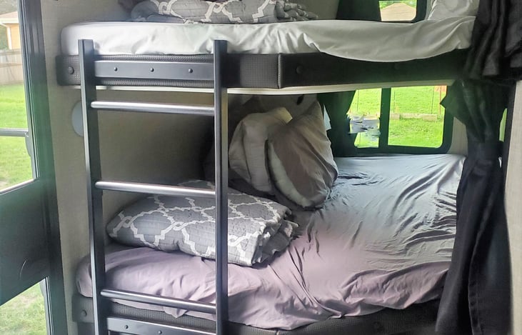 Top Bunk has a weight limit of 300 lbs. & bottom bunk 600 lbs. Each bunk has a plug and USB port. Each window opens completely.