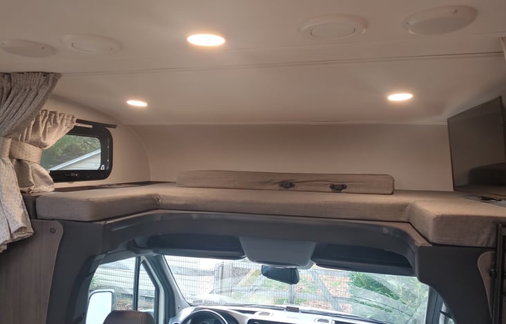 Provides ample headroom for driver. Easy in and out while driving. No hunching over as in RVs on Ford chasis.