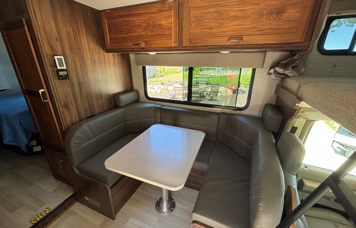 Dinette, table drops down to complete a bed that sleeps 2. Storage under all 3 seats.