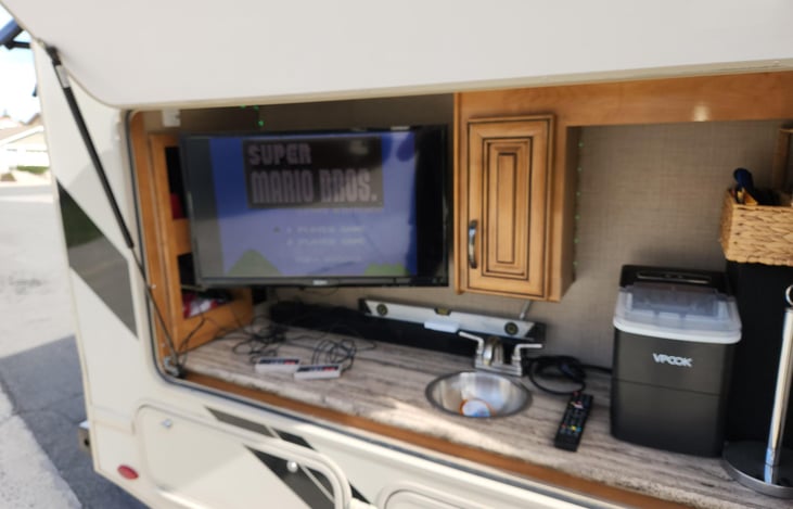 Outdoor bar with 32" tv, Sound bar, Nintendo, sink and optional ice maker.