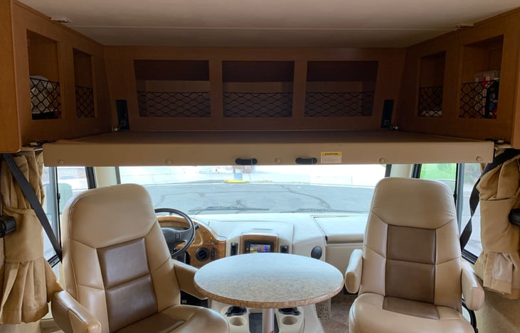 Drop down overhead bed with ladder attachment