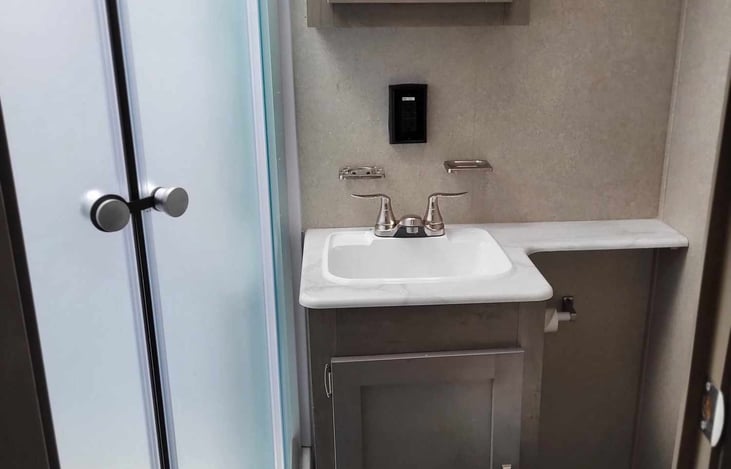 Bathroom includes shower, sink, and toilet