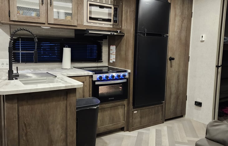 Microwave, Fridge, Freezer and Gas Stove/Oven.