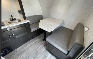 Yes it has a bathroom. Small easy to tow 3200lbs.