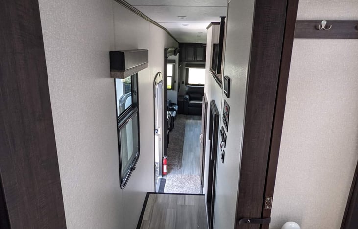 Steps/ walkway leading from the master bedroom to the bathroom door on the right.