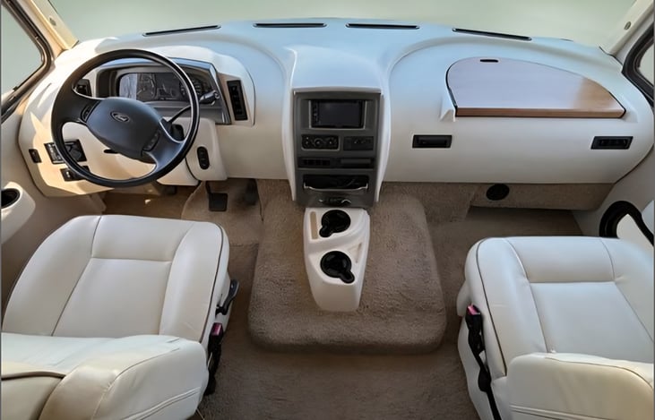 super comfy chairs, rear and side view cameras contribute to an easy drive. Powerful V10 can conquer any hill. Fuel economy is not great, but an 80 gallon fuel tank makes long trips easy. Cold AC!