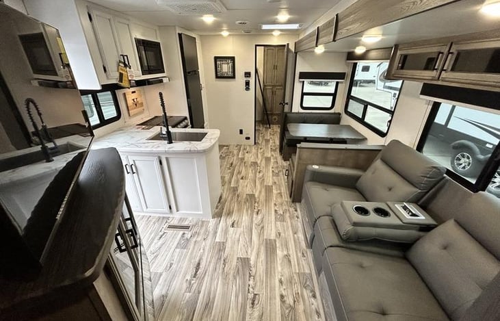 Large living area with TV, stereo system and fireplace.  Reclining  chairs, heated and with vibration.  Large pantry and plenty of storage