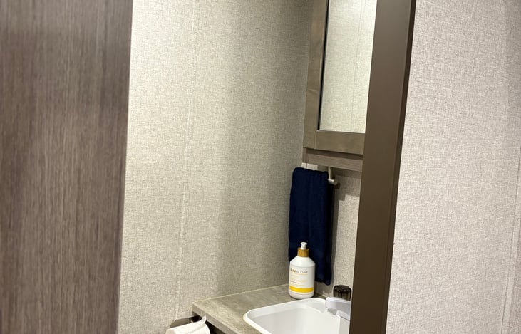 Master suite has a half bath. Toilet and sink with a medicine cabinet.