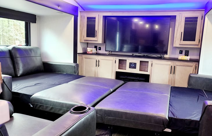 Two pull out sofas, 2-steater love seat with cup holders, fireplace and 5-in Tv.