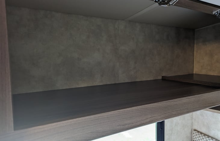 Empty cabinet over the queen corner bed for storing your personal items