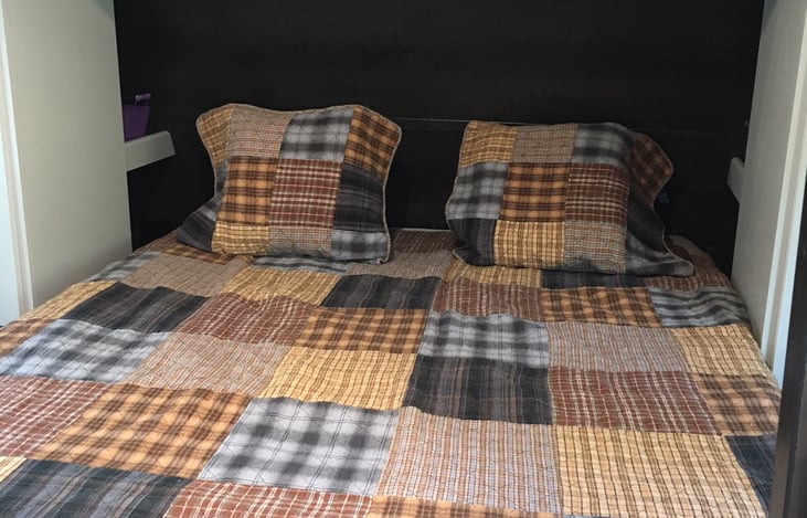 The private master bedroom with an upgraded queen-sized memory foam mattress is ready for you to unwind and sleep well. There are USB ports and multiple shelves on each side at the head of the bed.