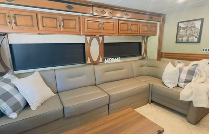 The extra long L shaped couch is great for stretching out and relaxing after your daily adventures. The left side of it houses a queen size air mattress for sleeping 2 additional guests/children.