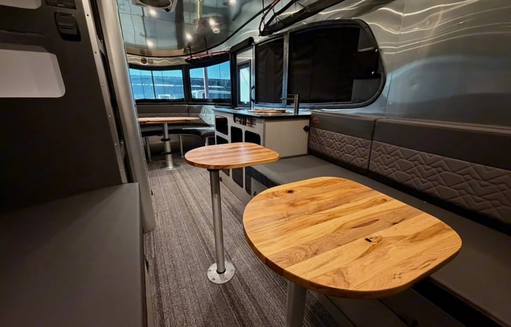 The interior of the Basecamp 20X pairs sleek aluminum with warm, updated pecan wood surfaces on the tables and countertops. Underfoot, the commercial-grade flooring provides a rugged, textured surface