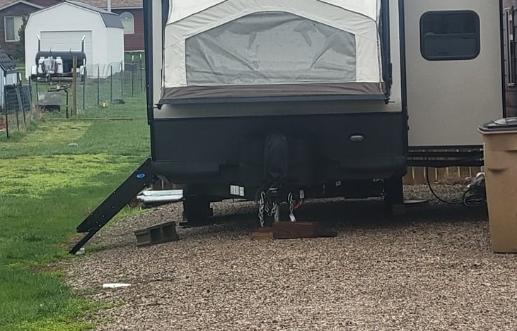 Front showing bed lowered and slide out. You can also see the air conditioning units and satellite.