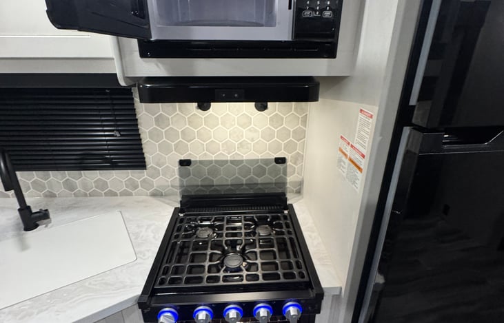 Stove, oven, microwave and exhaust fan.