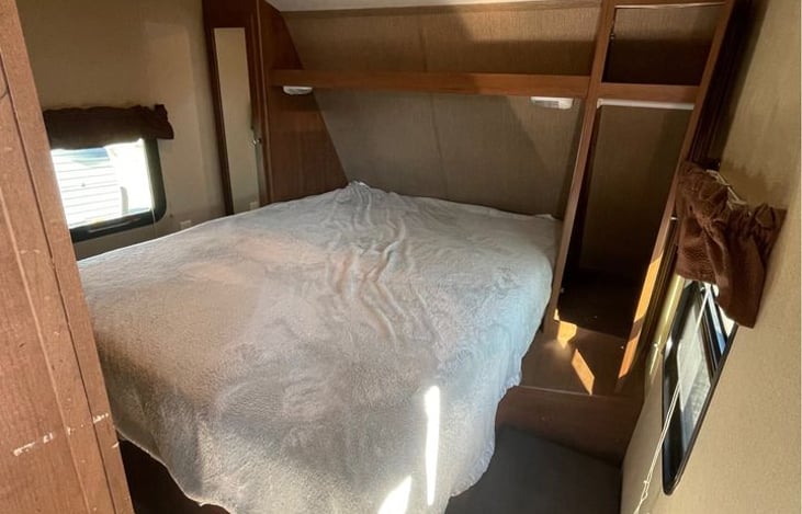 Memory foam queen size bed with storage underneath as well as privacy doors to bedroom