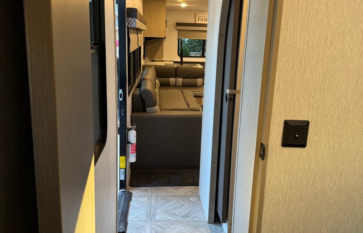 Looking from the main bedroom past the bathroom and entrance to the mail living area and kitchen.