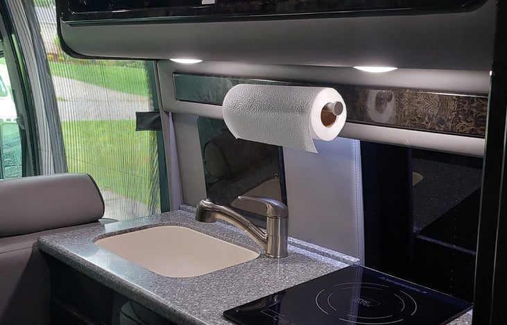 The induction cooking surface and sink are expectly small but functional.